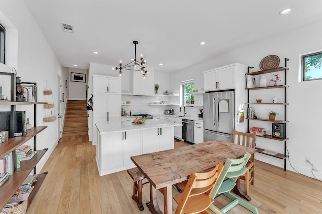 4614 Gillis St Unit 1, Austin, TX 78745 - kitchen featuring appliances with stainless steel finishes, open shelves, a sink, a chandelier, and light countertops