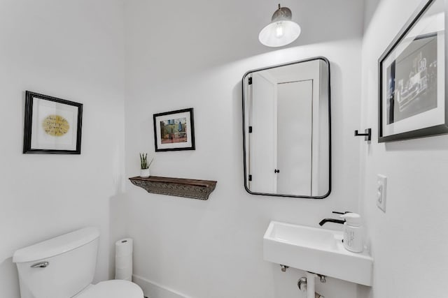 4614 Gillis St Unit 1, Austin, TX 78745 - bathroom featuring toilet, a sink, and baseboards