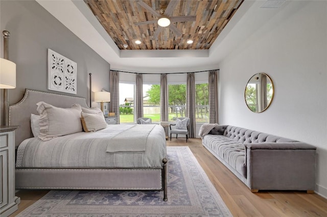 125 Reataway Dr, Dripping Springs, TX 78620 - bedroom featuring a raised ceiling, wood ceiling, and light wood-style flooring