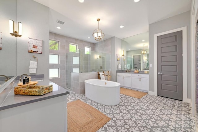 125 Reataway Dr, Dripping Springs, TX 78620 - bathroom with a shower stall, a freestanding bath, tile patterned floors, recessed lighting, and vanity