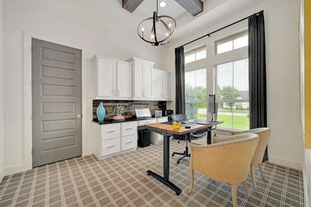 125 Reataway Dr, Dripping Springs, TX 78620 - home office featuring a towering ceiling, a chandelier, beamed ceiling, baseboards, and light carpet
