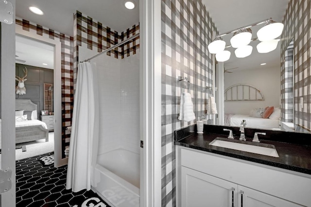 125 Reataway Dr, Dripping Springs, TX 78620 - ensuite bathroom with shower / bath combo, recessed lighting, vanity, and wallpapered walls