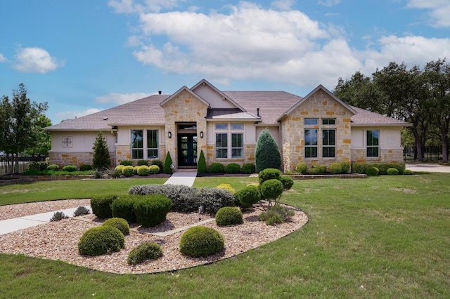 125 Reataway Dr, Dripping Springs, TX 78620 - view of front of home featuring stone siding, stucco siding, a front yard, and french doors