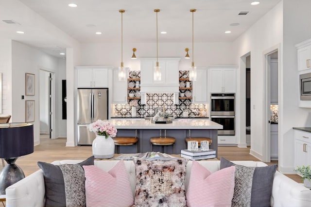 125 Reataway Dr, Dripping Springs, TX 78620 - kitchen with appliances with stainless steel finishes, open floor plan, backsplash, and recessed lighting
