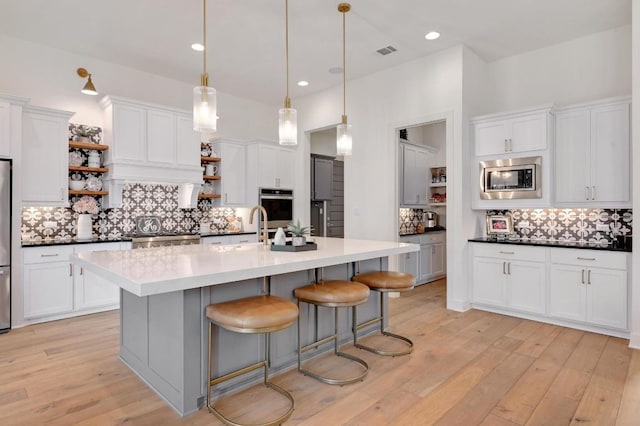 125 Reataway Dr, Dripping Springs, TX 78620 - kitchen featuring open shelves, stainless steel appliances, tasteful backsplash, white cabinetry, and recessed lighting
