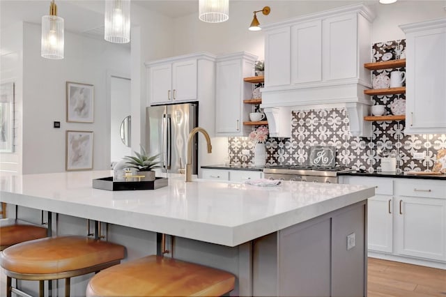 125 Reataway Dr, Dripping Springs, TX 78620 - kitchen featuring open shelves, freestanding refrigerator, tasteful backsplash, and white cabinets