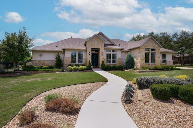 125 Reataway Dr, Dripping Springs, TX 78620 - view of front facade featuring stone siding, a front lawn, stucco siding, and a standing seam roof