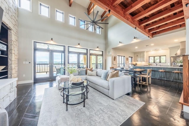 516 Deckhouse Dr, Point Venture, TX 78645 - living room with beam ceiling, a towering ceiling, wooden ceiling, a fireplace, and ceiling fan
