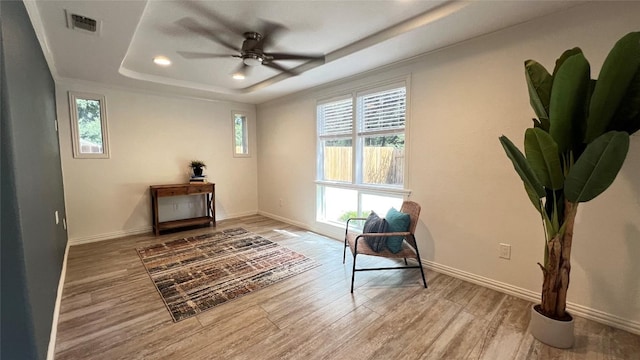4807 Gerona Dr, Austin, TX 78759 - living area featuring a raised ceiling, healthy amount of natural light, recessed lighting, wood finished floors, and a ceiling fan