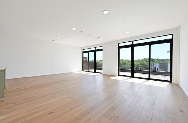 2209 S 1st St Unit 408, Austin, TX 78704 - unfurnished room featuring light wood finished floors, baseboards, and recessed lighting
