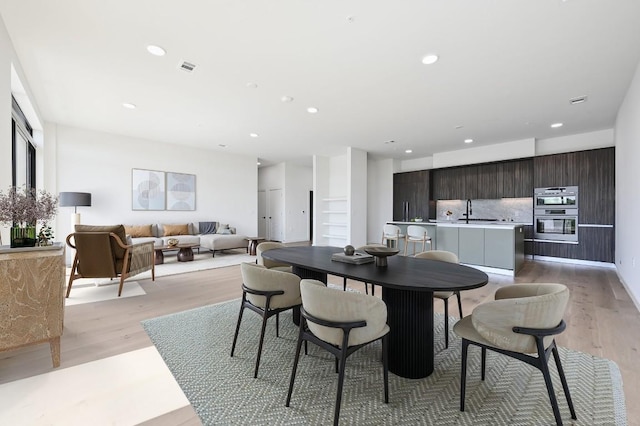 2209 S 1st St Unit 408, Austin, TX 78704 - dining room featuring light wood finished floors and recessed lighting