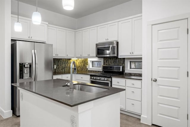 2011 Haskell St Unit A, Austin, TX 78702 - kitchen with stainless steel appliances, dark countertops, a sink, tasteful backsplash, and white cabinetry