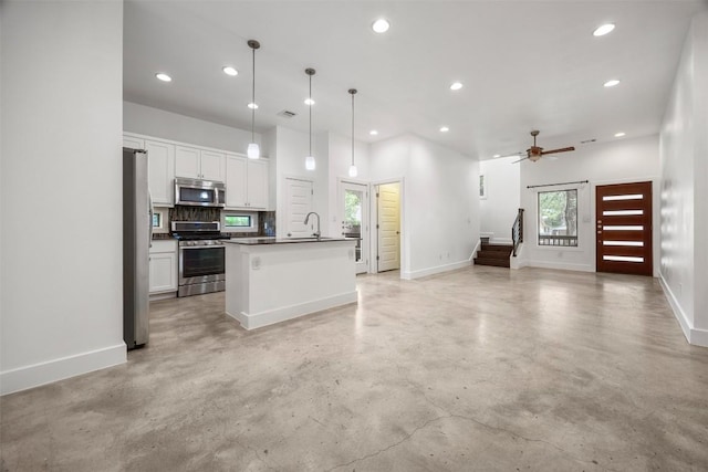 2011 Haskell St Unit A, Austin, TX 78702 - kitchen featuring stainless steel appliances, finished concrete floors, open floor plan, baseboards, and recessed lighting