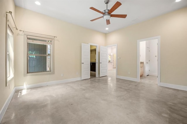 2011 Haskell St Unit A, Austin, TX 78702 - unfurnished bedroom with finished concrete floors, a walk in closet, recessed lighting, baseboards, and connected bathroom