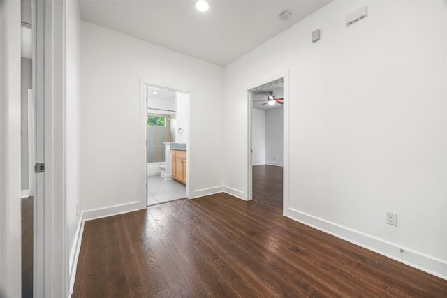 2011 Haskell St Unit A, Austin, TX 78702 - unfurnished bedroom with dark wood-type flooring, baseboards, and connected bathroom