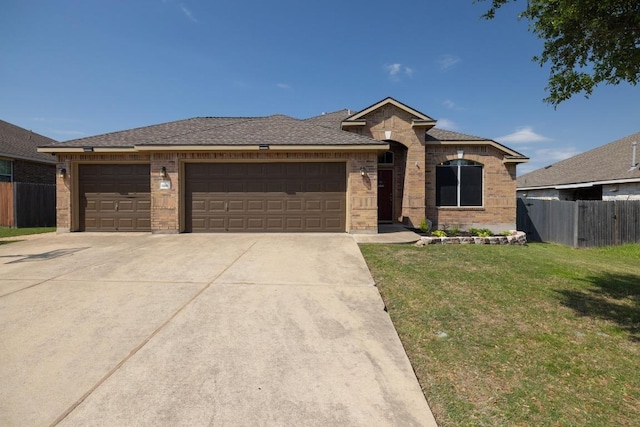ranch-style home with a garage, concrete driveway, fence, a front yard, and brick siding