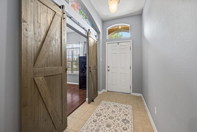 1416 Muddy Waters Dr, Pflugerville, TX 78660 - entrance foyer featuring a barn door and light tile patterned flooring