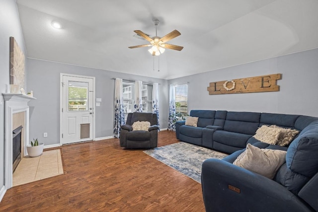 1416 Muddy Waters Dr, Pflugerville, TX 78660 - living area with a ceiling fan, healthy amount of natural light, wood finished floors, and a tile fireplace