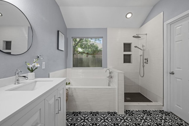 1416 Muddy Waters Dr, Pflugerville, TX 78660 - full bath featuring vaulted ceiling, vanity, a garden tub, walk in shower, and tile patterned floors