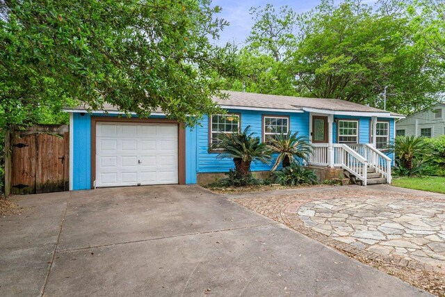 4701 Milburn Ln, Austin, TX 78702 - view of front facade featuring driveway and an attached garage