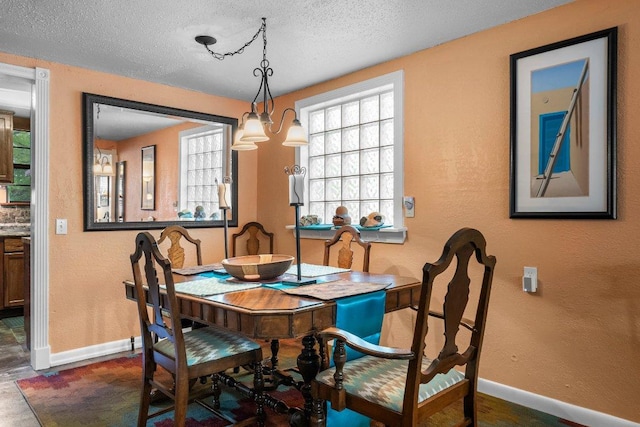 4701 Milburn Ln, Austin, TX 78702 - dining room featuring baseboards, a textured ceiling, and a textured wall