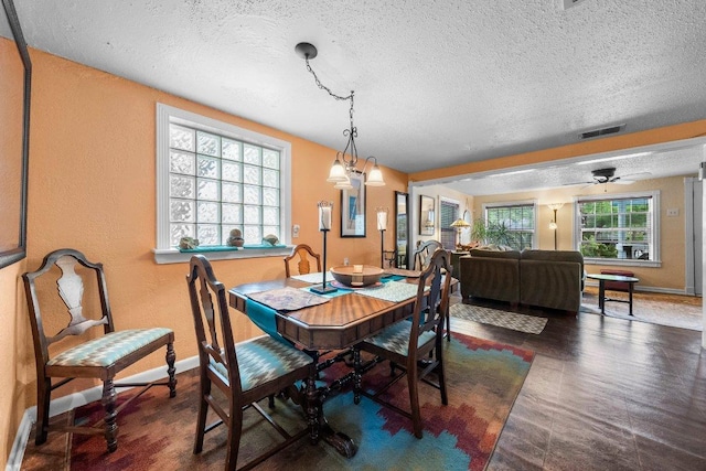 4701 Milburn Ln, Austin, TX 78702 - dining area with a textured ceiling, baseboards, and a textured wall