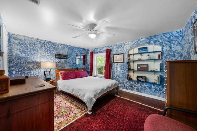 4701 Milburn Ln, Austin, TX 78702 - bedroom with wallpapered walls, baseboards, wood finished floors, and ceiling fan