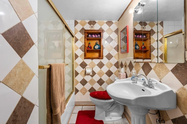 4701 Milburn Ln, Austin, TX 78702 - full bathroom with toilet, tile walls, and shower / bath combination with glass door