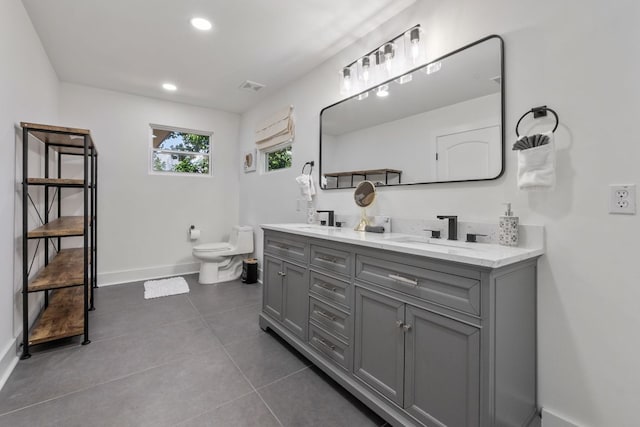 5800 Marilyn Dr, Austin, TX 78757 - bathroom featuring double vanity, tile patterned floors, and recessed lighting