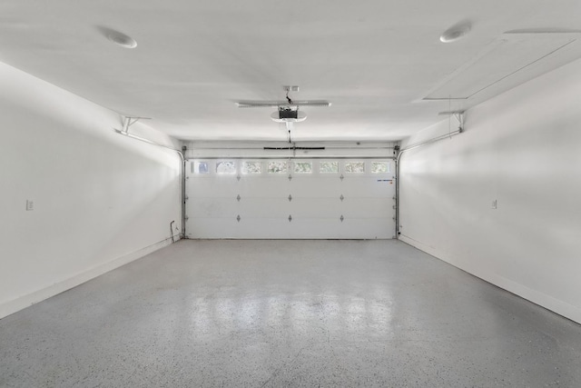 5800 Marilyn Dr, Austin, TX 78757 - garage featuring a garage door opener and baseboards