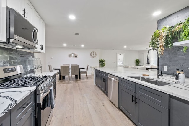 5800 Marilyn Dr, Austin, TX 78757 - kitchen featuring stainless steel appliances, light stone countertops, decorative backsplash, and recessed lighting