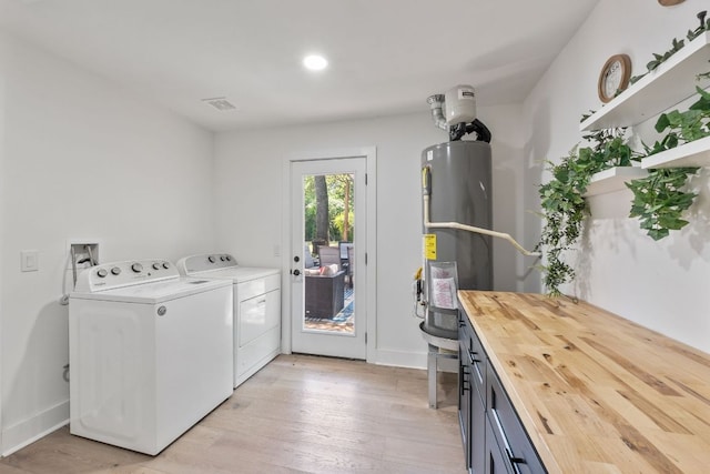 5800 Marilyn Dr, Austin, TX 78757 - laundry room featuring independent washer and dryer, secured water heater, light wood-type flooring, and recessed lighting