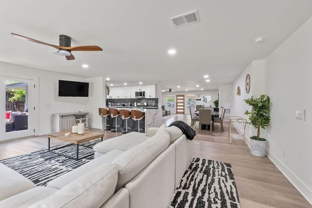 5800 Marilyn Dr, Austin, TX 78757 - living room with ceiling fan, light wood-type flooring, baseboards, and recessed lighting