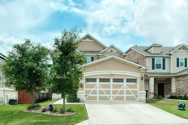 craftsman inspired home with stucco siding, an attached garage, concrete driveway, stone siding, and a front yard