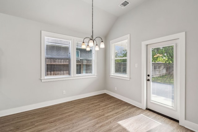206 N Winston Dr, Fredericksburg, TX 78624 - unfurnished dining area featuring baseboards, visible vents, an inviting chandelier, lofted ceiling, and wood finished floors