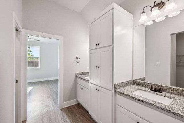 206 N Winston Dr, Fredericksburg, TX 78624 - full bathroom with vaulted ceiling, a ceiling fan, wood finished floors, vanity, and baseboards