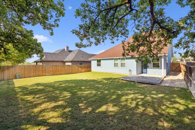 206 N Winston Dr, Fredericksburg, TX 78624 - back of house with a fenced backyard, a patio area, a yard, and stucco siding