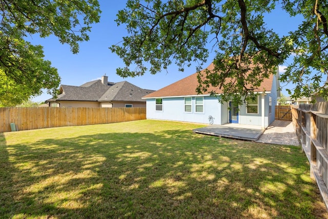 206 N Winston Dr, Fredericksburg, TX 78624 - back of house featuring a yard, a shingled roof, a fenced backyard, and stucco siding