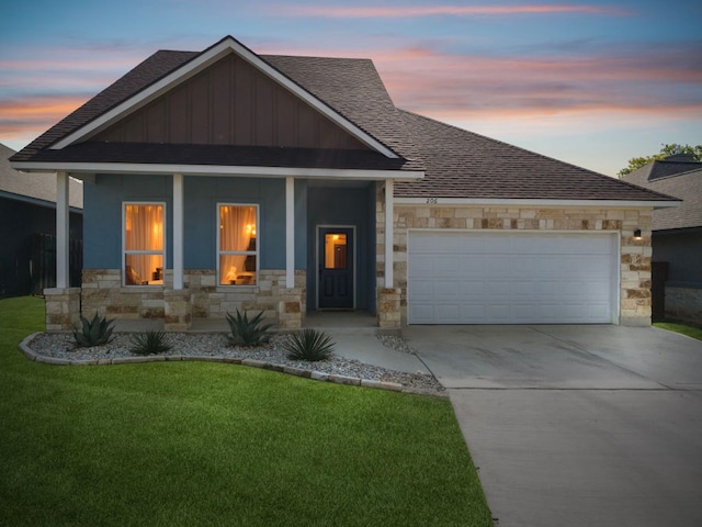206 N Winston Dr, Fredericksburg, TX 78624 - view of front of house with stone siding, a porch, driveway, and roof with shingles