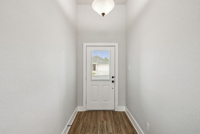 206 N Winston Dr, Fredericksburg, TX 78624 - doorway with baseboards and dark wood finished floors