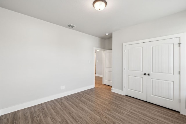 206 N Winston Dr, Fredericksburg, TX 78624 - unfurnished bedroom featuring a closet, wood finished floors, visible vents, and baseboards