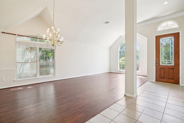 10120 Treasure Island Dr, Austin, TX 78730 - foyer entrance featuring vaulted ceiling, a chandelier, wood finished floors, and baseboards