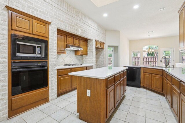 10120 Treasure Island Dr, Austin, TX 78730 - kitchen featuring black appliances, a sink, under cabinet range hood, brown cabinetry, and recessed lighting