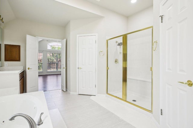 10120 Treasure Island Dr, Austin, TX 78730 - full bath featuring a stall shower, a jetted tub, vanity, baseboards, and vaulted ceiling