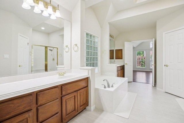 10120 Treasure Island Dr, Austin, TX 78730 - full bathroom with vaulted ceiling, a shower stall, vanity, and a bath