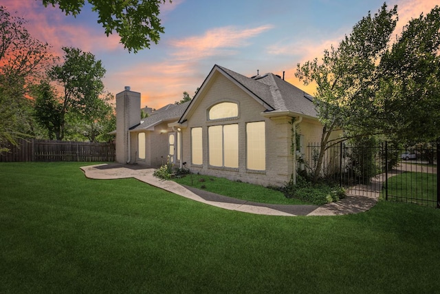 10120 Treasure Island Dr, Austin, TX 78730 - rear view of house featuring a chimney, a patio, a shingled roof, and brick siding