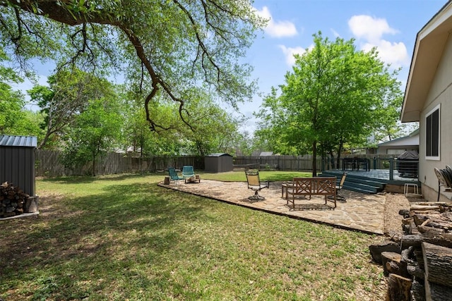 12511 Tree Line Dr, Austin, TX 78729 - view of yard with a storage unit, a patio area, and an outbuilding