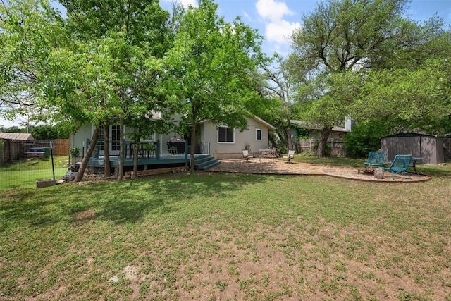 12511 Tree Line Dr, Austin, TX 78729 - view of yard featuring a deck, a storage unit, an outbuilding, a fire pit, and a patio