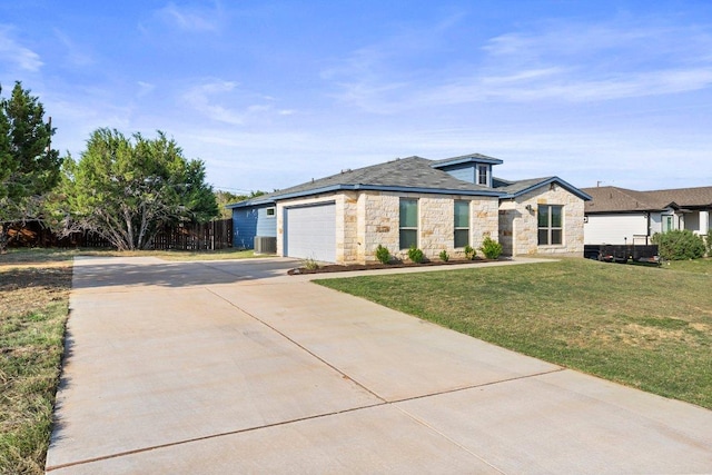 view of front facade with stone siding, concrete driveway, a garage, and central air condition unit