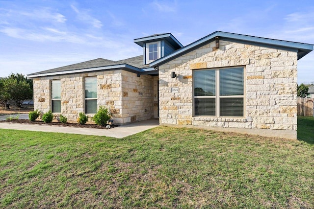 view of front of property featuring stone siding and a front yard